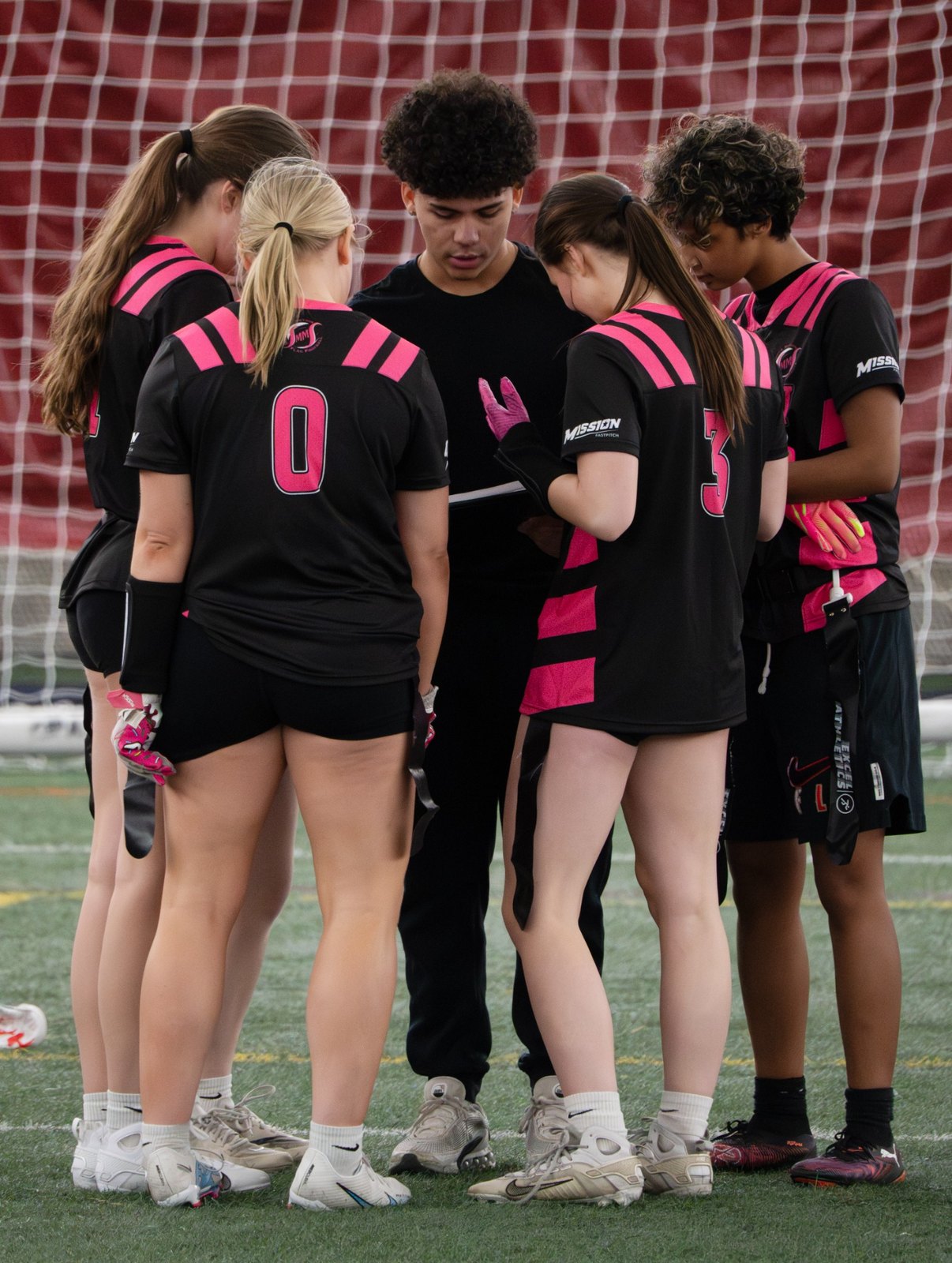 Minnesota Motion athletes in a team huddle with a coach
