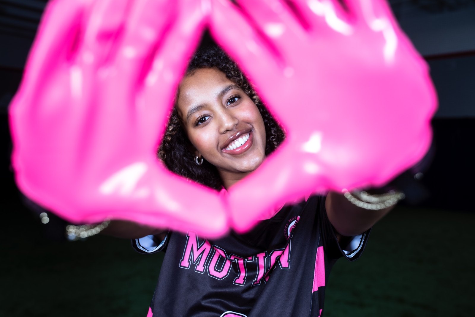 Minnesota Motion athlete holding pink gloves toward the camera